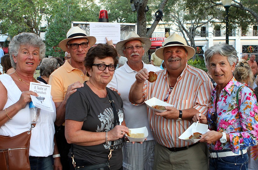 Susanne Seligson, Leif Kamtsan, Ted Kamtsan, Ruth Kamtsan, Dennis and Harriet Rafkin pose together with their latkes during A Taste of Chanukah, Tuesday, Dec. 20 at Five Points Park. The whole group was from Finland.