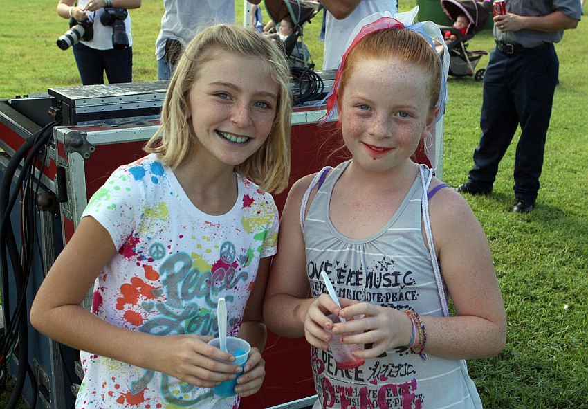 Alexus Fleming, 10, and Brianna Robbison, 10, enjoy their blue and red Italian icees Sunday, Sept. 11, at Payne Park.