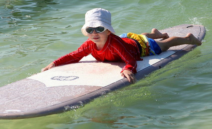 Harrison Troyan, 4 Â½, has a good time riding in towards shore during the Hang Ten for Autism surf event Saturday, Sept. 17, at the Siesta Key Public Beach.