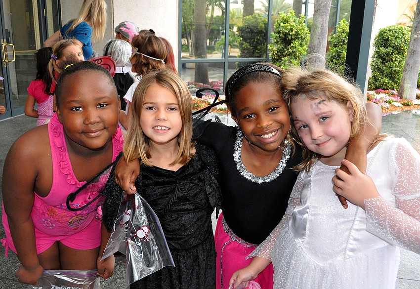 Ashanti Robinson, Sage Smith, Chloe Sebiro and Toni Pannell pose together, Friday, Oct. 28, during their trick-or-treating event at the Sarasota City Center Office Building.