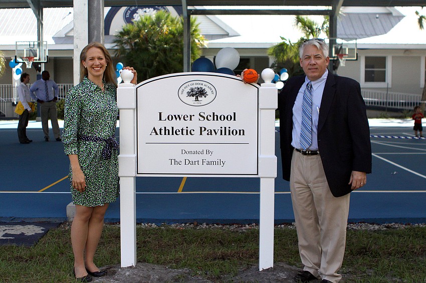 Ariane Dart poses with the President of the Board of Trustees, Michael vonWaldner, Monday, Oct. 31, as part of the opening of the Lower School Athletic Pavilion donated by the Dart Family at Out-of-Door Academy.