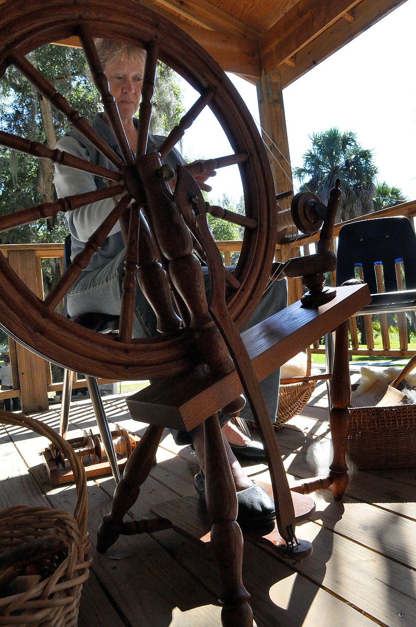 Anne Savage did a demonstration in spinning wool on the back porch of the Bidwell-Wood house, Saturday, Nov. 12, during Pioneer Day.