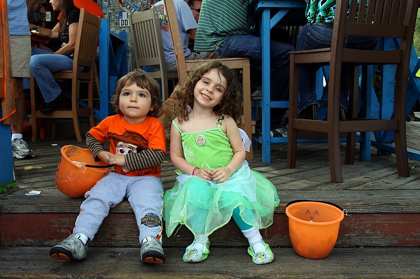 August, 2, and April, 4, Turner sit on the steps at the Siesta Key Oyster Bar.