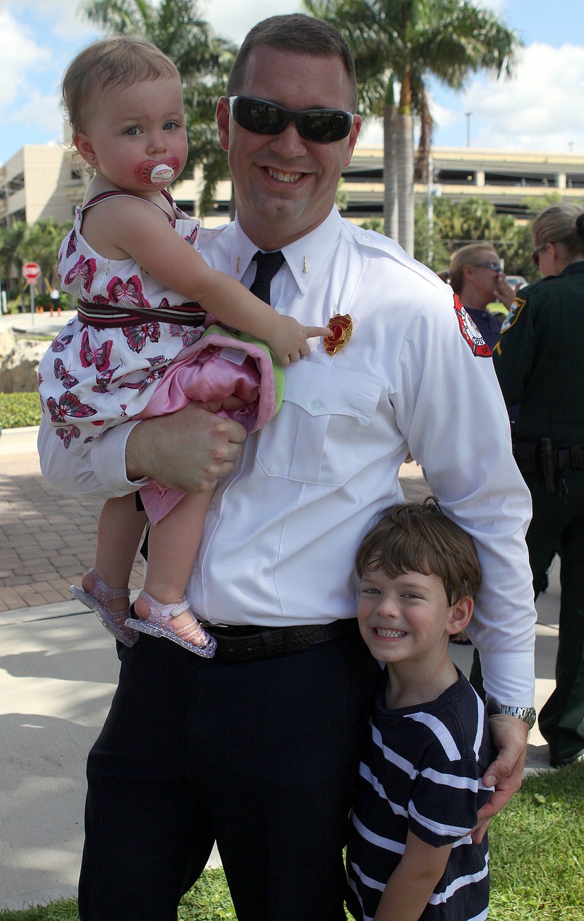 Firefighter Steve Rose poses with his daughter, Taytum, 18 mos., and son, Jonathon, 6, Sunday, Sept. 11, at Payne Park.