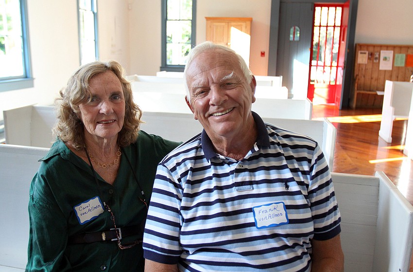 Carol and Frank VonAllmen pose together in one of the pews inside Crocker Memorial Church.