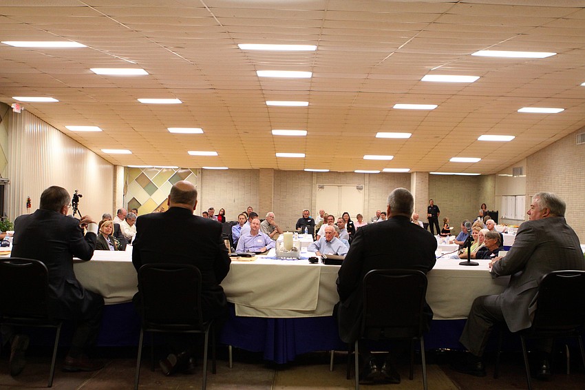 The four candidates sat up on a small stage inside the Potter Building and answered questions from the crowd.
