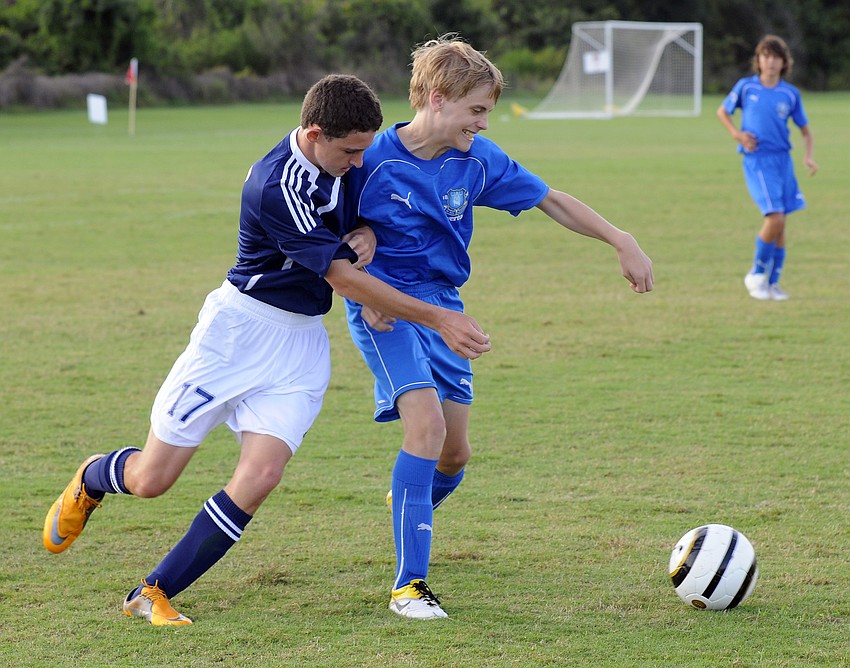 Thirteen-year-old Ari Rosenberg and Aaron Gray, 14, battle for the ball during the opening day of the tournament.