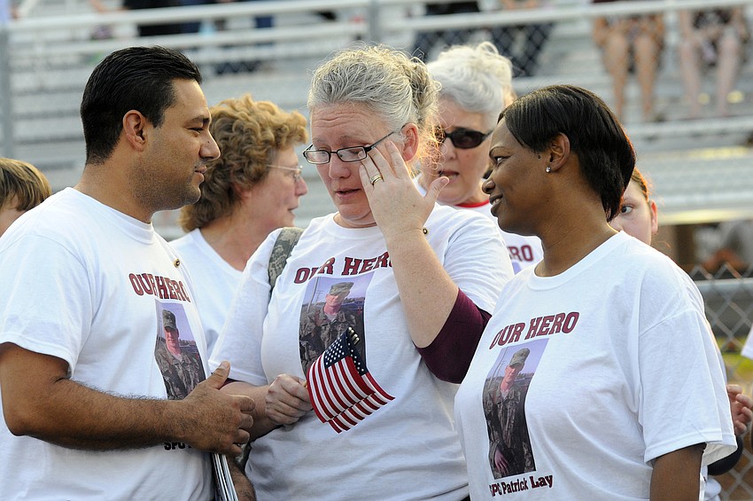 U.S. Army Spc. 4 Patrick Lay IIâ€™s mother, Stefenie Hernandez, reminisces with her husband, Art, and best friend, Amy Storey before her son's memorial Sept. 16.