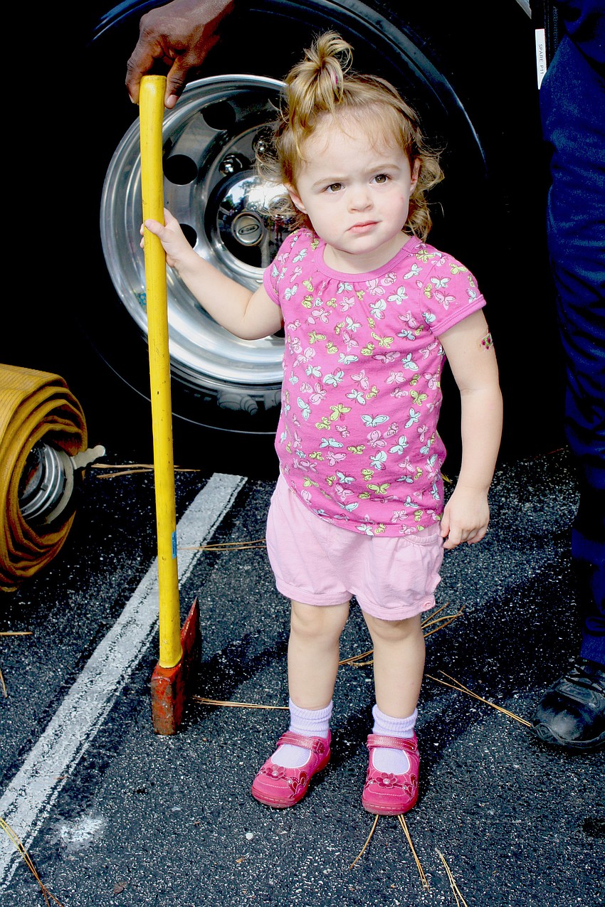 Firefighter-in-training Avrey Carver is ready to break some doors in with the truckâ€™s axe.