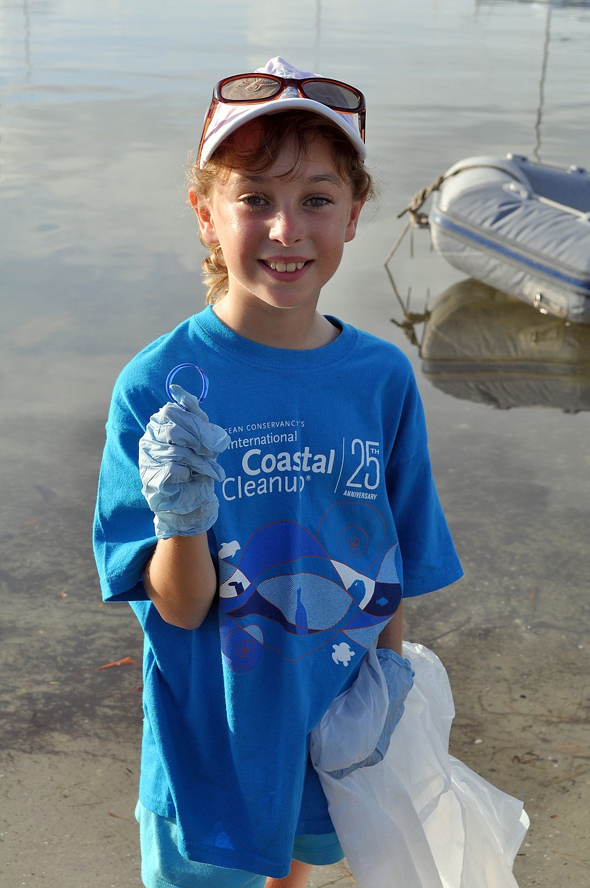 Maggie Mazzella, 8, shows some plastic she found along the shore at Bayfront Park Saturday, Sept. 24, during the International Coastal Cleanup.