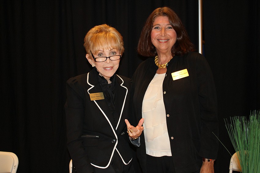 Founder Ivona Adams-Smith and board Member Patty Finley pose in front of their Mission: Seniors International booth.