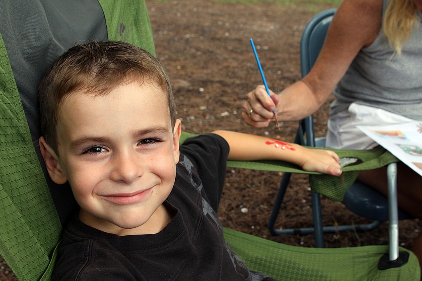 Draven Bean, 8, got a hermit crab painted onto his arm during the Local National Estuaries Day Celebration Saturday, Sept. 24, at Ken Thompson Park.
