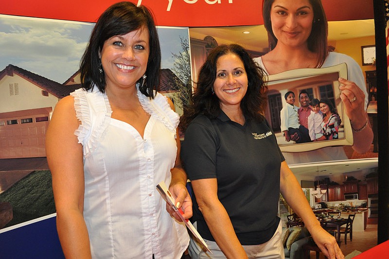 Taylor Morrison representatives Maria Amundson and Mary Anne Givens spread the news about the homebuilder's newest community, Esplanade.