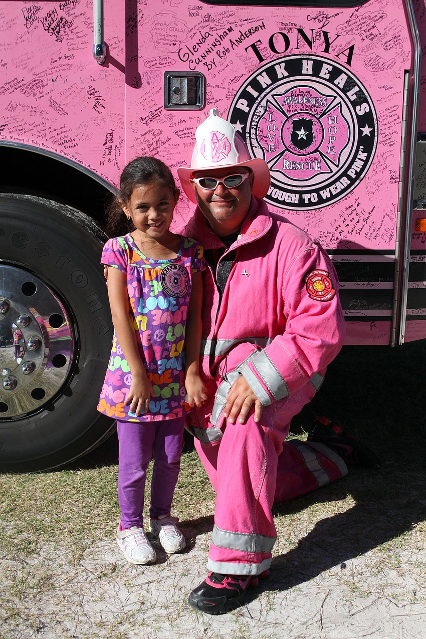 Sofia Benitez, 6, poses with Matthew Medeiros in front of 
