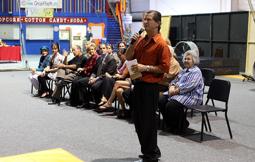 Pedro Reis talks to the crowd as members of Circus Sarasota and Sailor Circus sit behind him.