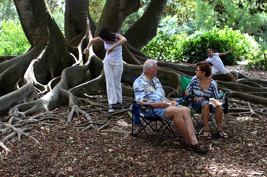 Jerry and Nancy Schrantz were shocked to find Fuzion Dance Artists coming out from behind a Banyan tree they were sitting front of Sunday, Oct. 9 during GartenFest at Marie Selby Botanical Gardens.