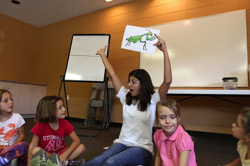 Jennifer Holt from GWiz shows off a picture of an insect, Tuesday, Oct. 25, to the preschoolers at St. Boniface Preschool.
