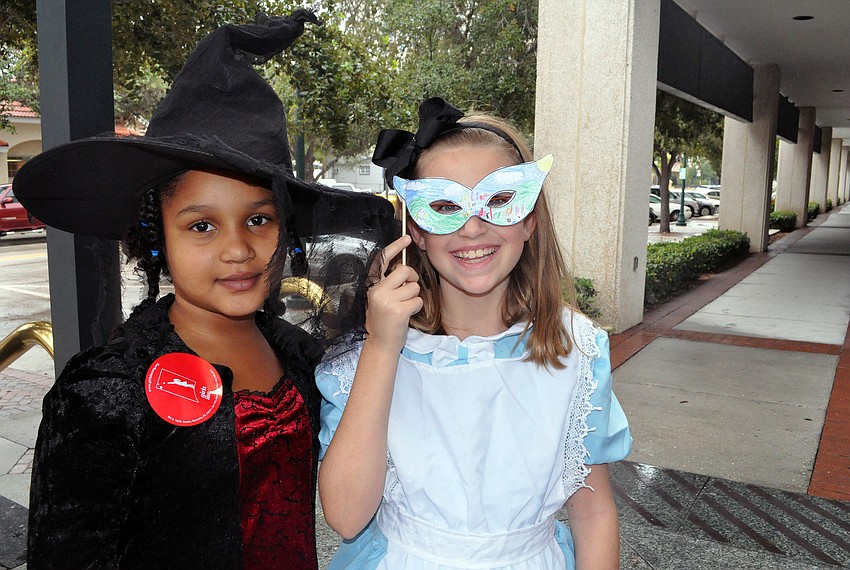Zoe Smith, dressed as a witch, and McClain Miller, dressed as Alice from â€œAlice in Wonderlandâ€.