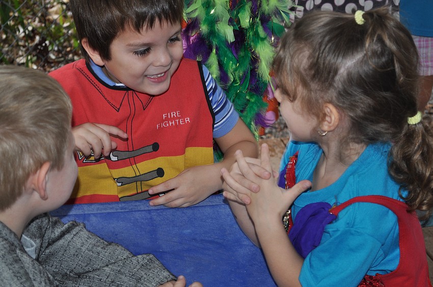 Giovanna Hansen asks Logan Lutz and Liam Lizotte what they would like to order for dinner.