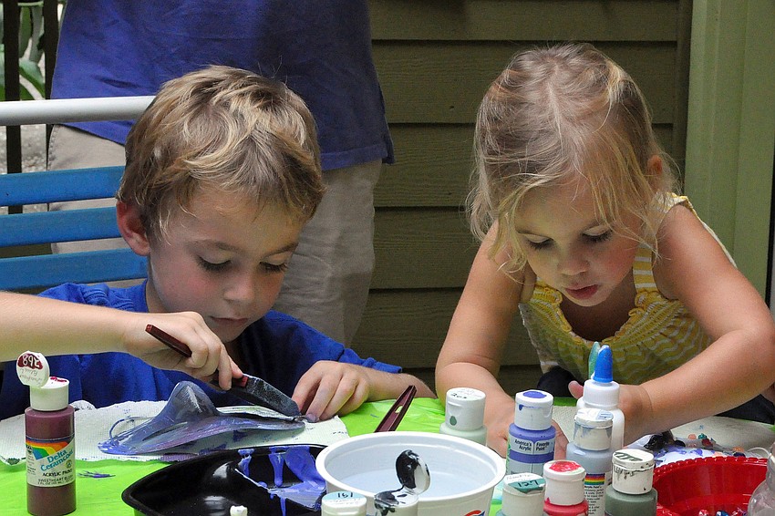 Jackson, 4, and Piper, 2, Bowman work on painting their masks, Saturday, Oct. 29, during Family Mask Day at Artists on the Court.