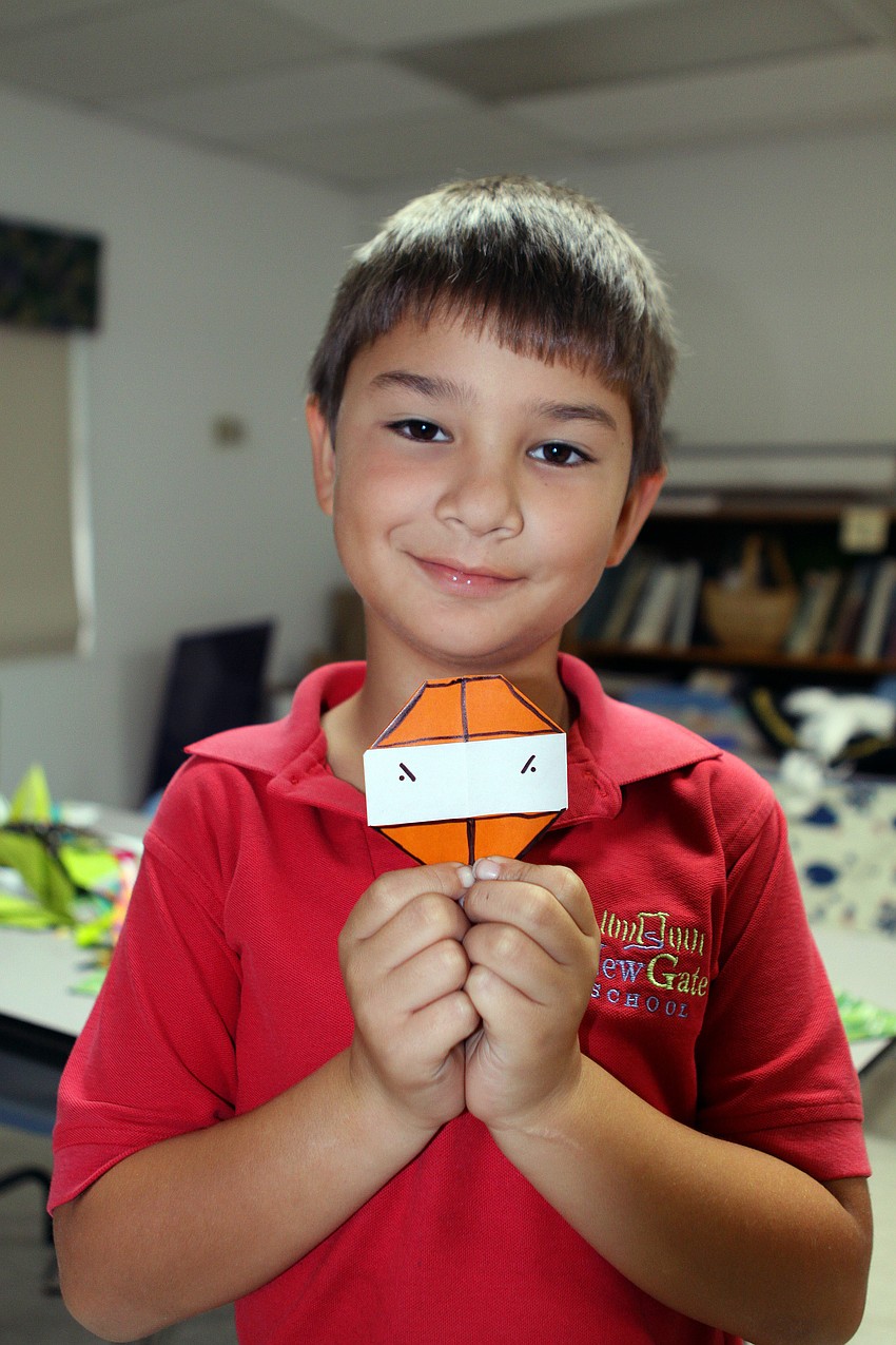 Evan Angeleri shows off the ninja he made while in â€œJapanâ€, Monday, Oct. 31, during International Children's Day at NewGate.
