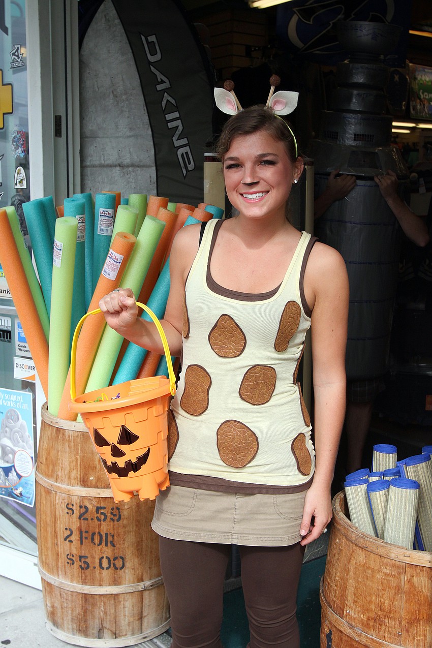 Magdalena Acuna handed out candy outside the Beach Bazaar, Monday, Oct. 31, during the Safe Kids trick-or-treating event in Siesta Key Village.