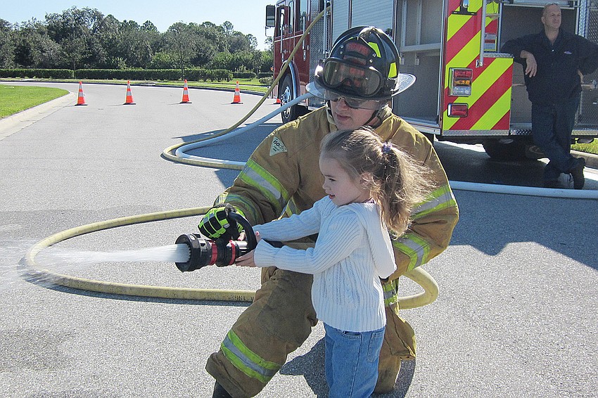 Katlyn Costello loved trying out the fire truck hose.