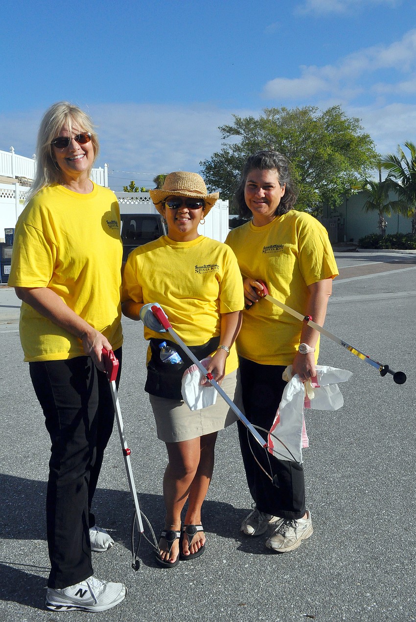 Catherine Luckner, Beverly Arais and Maria Shay pose with their clean up gear.