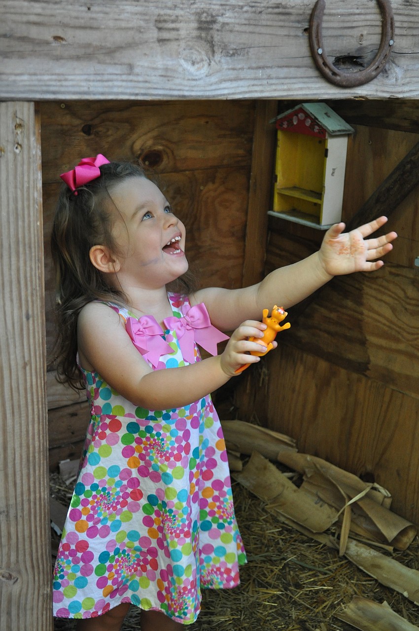 Camille Brooks plays a game of peek-a-boo with her mother.