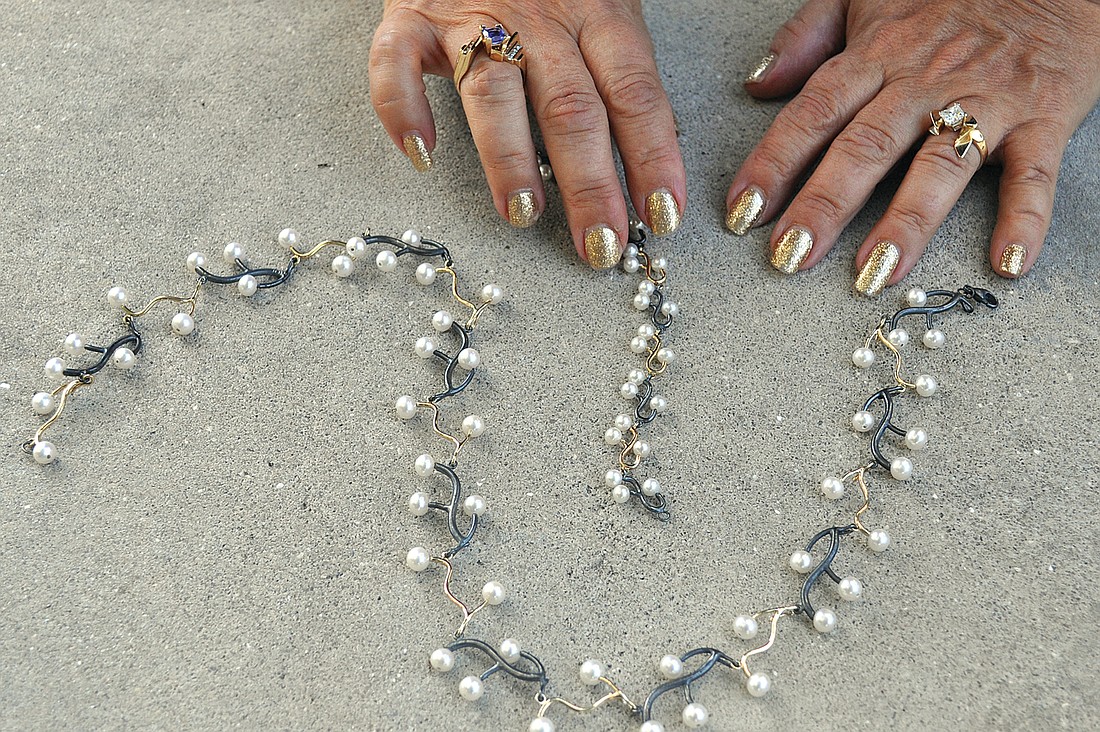 Joan Michlin's "Garland" bracelet and necklace is made from blackened silver, gold and pearls.