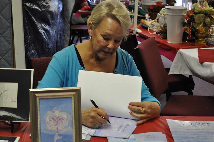 Celia Edmundson signs copies of her book, 