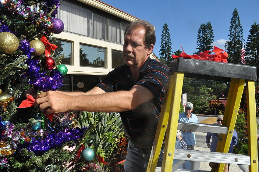 Assistant Mangaer Mark Meador gets the out-of-reach places.