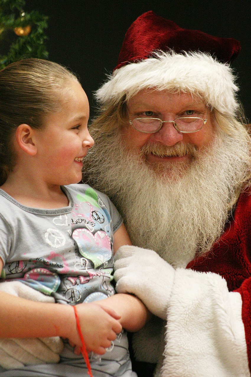 Rylee Buckner, 6, pulled on Santa's beard to ensure its authenticity.