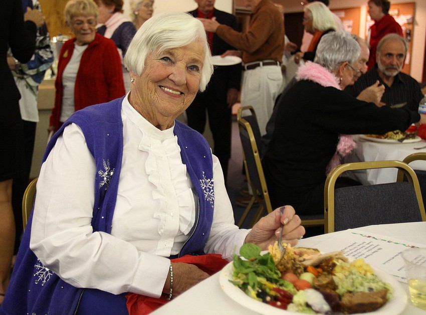 Barbara Bishop enjoys her meal at the Longboat Key Garden Clubâ€™s Candy Cane Lane holiday party.