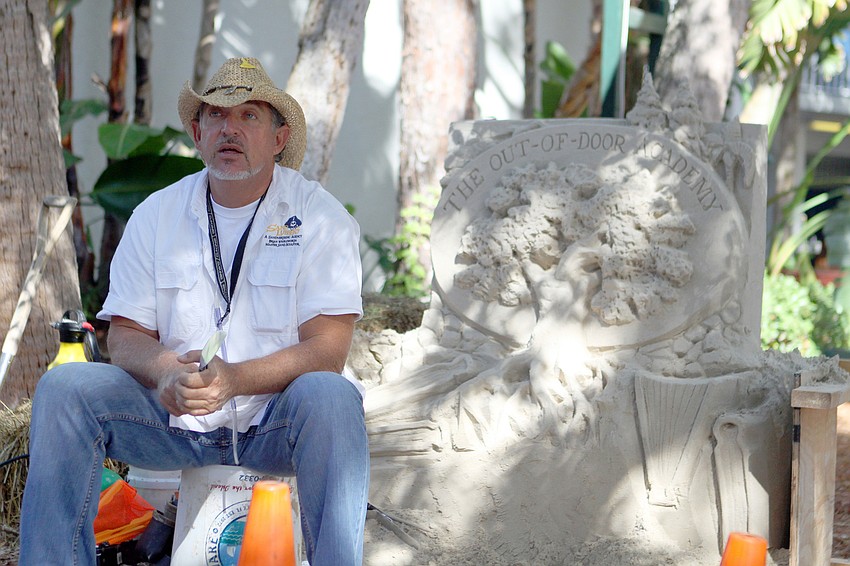 Brian Wigelsworth with his sand sculpture of ODAâ€™s logo.