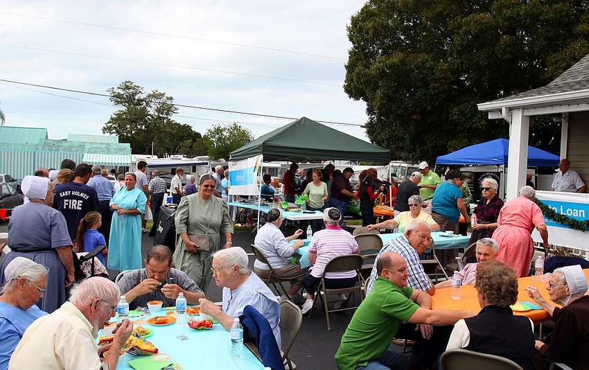 People enjoy eating chili and pieces of pie during the 1st annual pie contest, Friday, Dec. 9 at Everence Federal Credit Union.