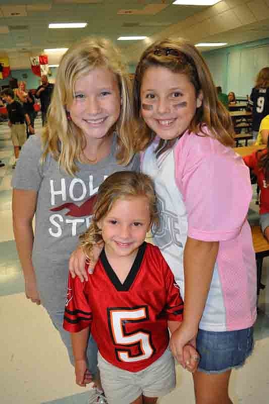 Tara Elementary graduates Courtney Bradley and Ashley Danko had fun with Miley Walker, 4.