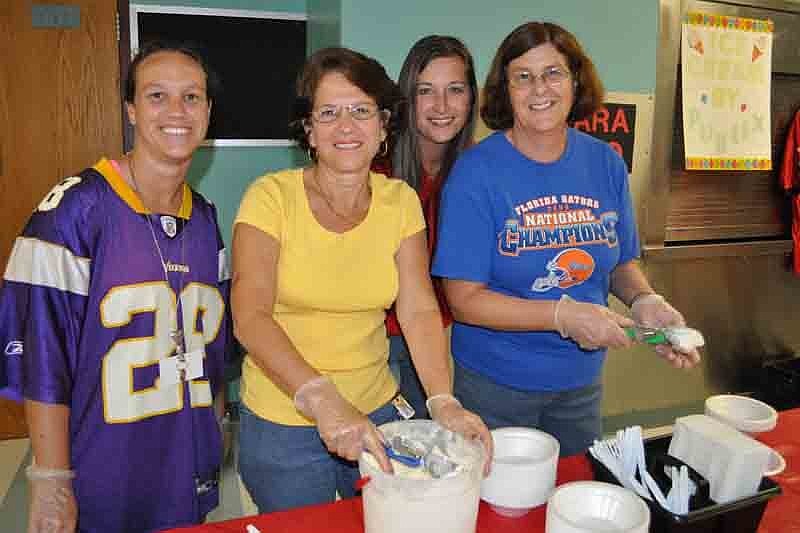 Teachers Jeanne Moore, Mary Searing, Kelly Walker and Tina Backhus dished out ice cream.