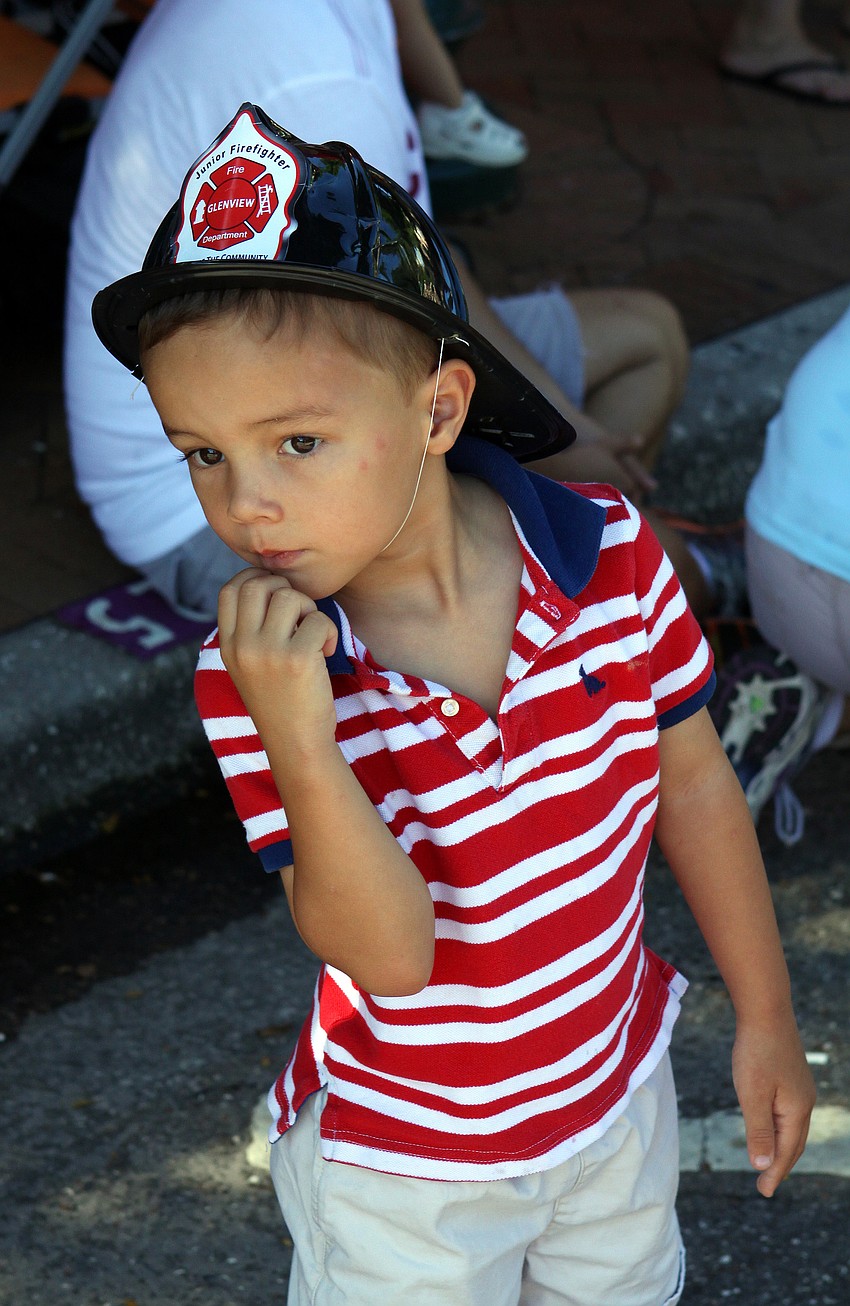 Martin Oâ€™Malley, 3, watches the fire trucks go by Sunday, Sept. 11, during the Remembrance March.