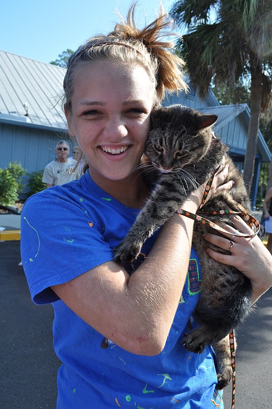 Rachel Gross tried to comfort her cat, Monday, who was nervous about being outside and around dogs.