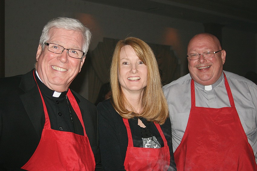 Bishop Frank J. Dewane, Margaret Gaitens, Deacon Kevin McKenney team up to cook.