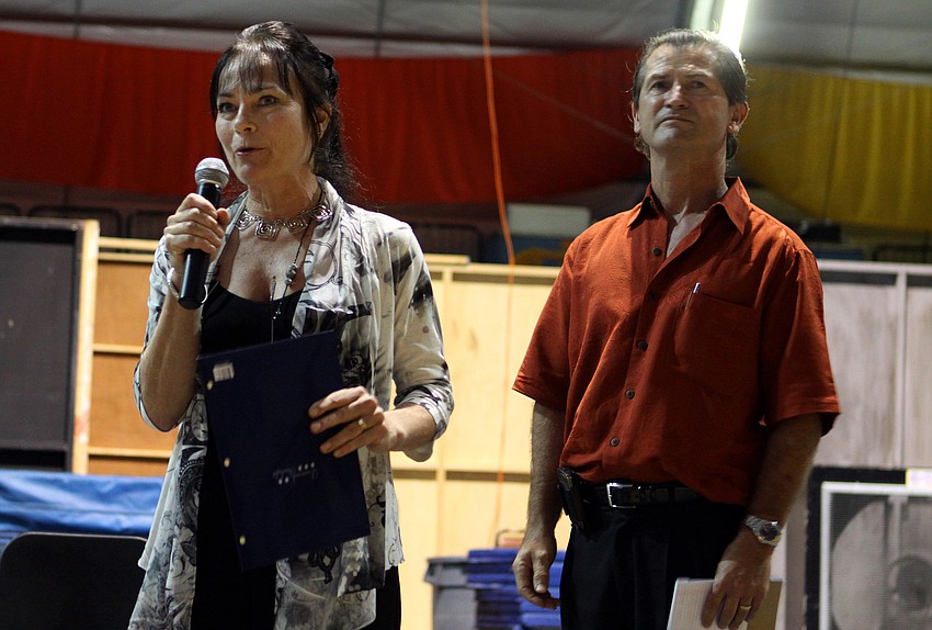 Dolly Jacobs talks to the crowd as Pedro Reis looks on.