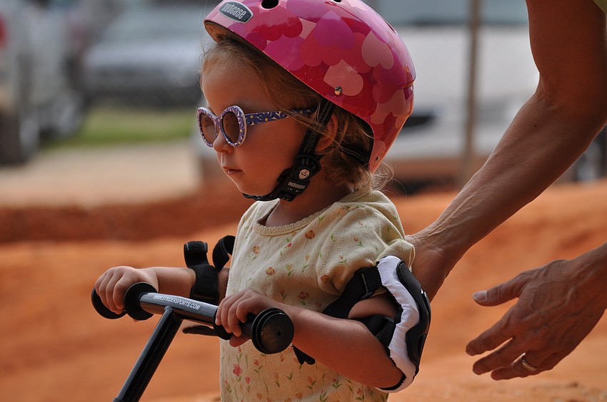 A toddler races around the track.
