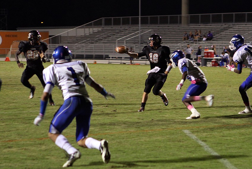 Austin Leach, No. 18, passes to Marlon Mack, No. 28, during the homecoming football game, Friday Oct. 14, at Cleland Stadium.
