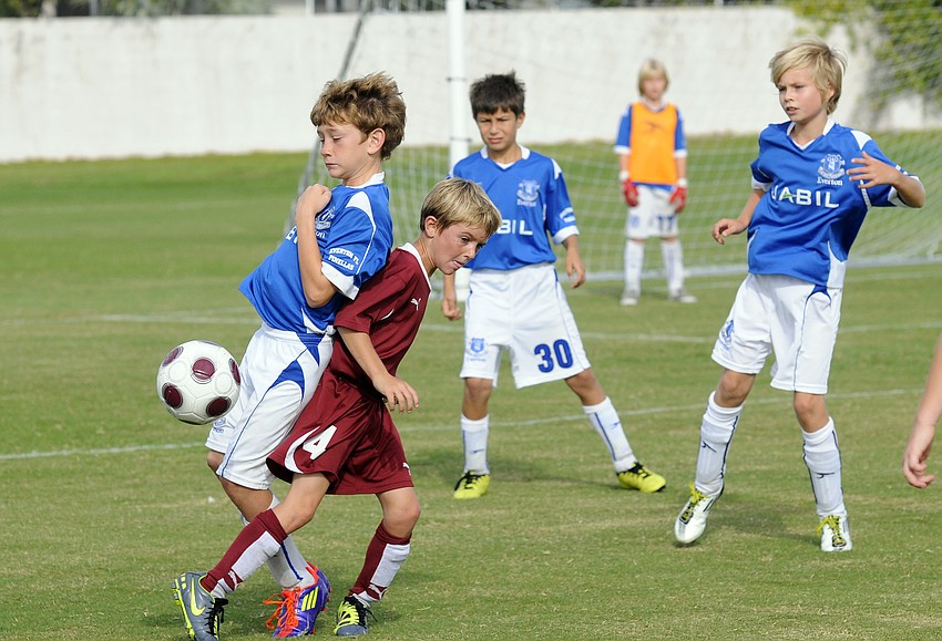 Nine-year-old Landon Ameres gets tangled up with an Everton defender.