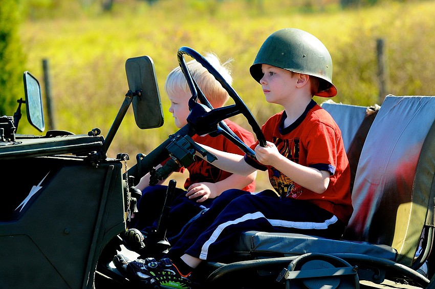 Five-year-old Montana Mead and his younger brother Grant, 3, enjoyed testing out the different military vehicles.