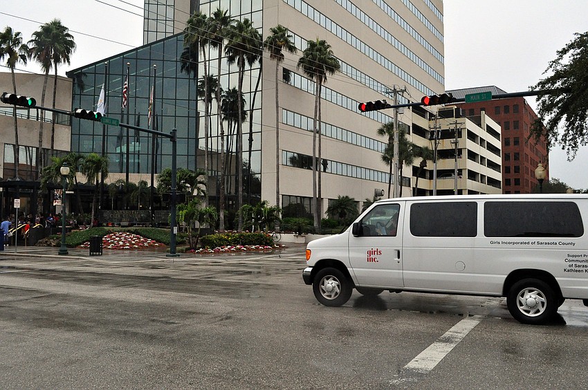 One of the Girls Inc. vans drives up to the Sarasota City Center Office Building to drop off more girls to go trick-or-treating.