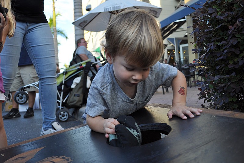 Preston Coleman was fascinated by the bean bag toss.
