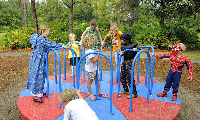 Children didnâ€™t lit a little rain earlier in the day keep them from playing on the playground.