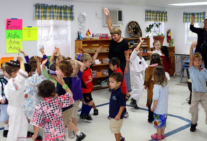 Bev Boardman and the youngest NewGate children move around like elephants in the â€œAfricaâ€ room, Monday, Oct. 31, during International Children's Day at NewGate.